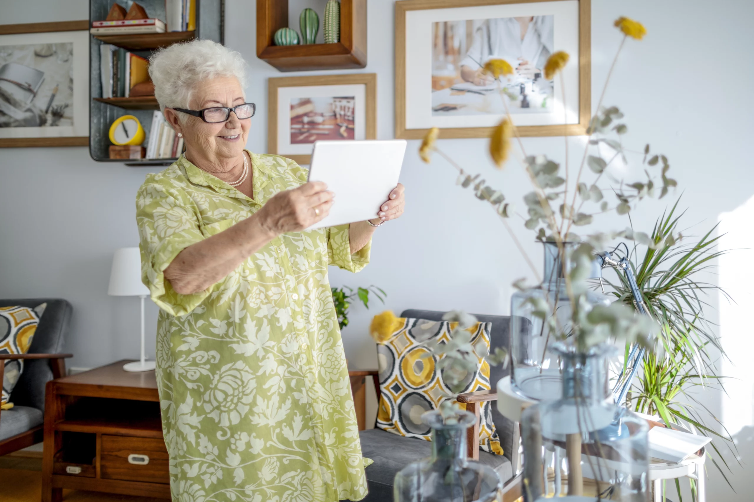 Older adult taking a picture of her personalized suite in retirement living.